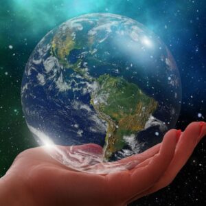 A hand holding small earth